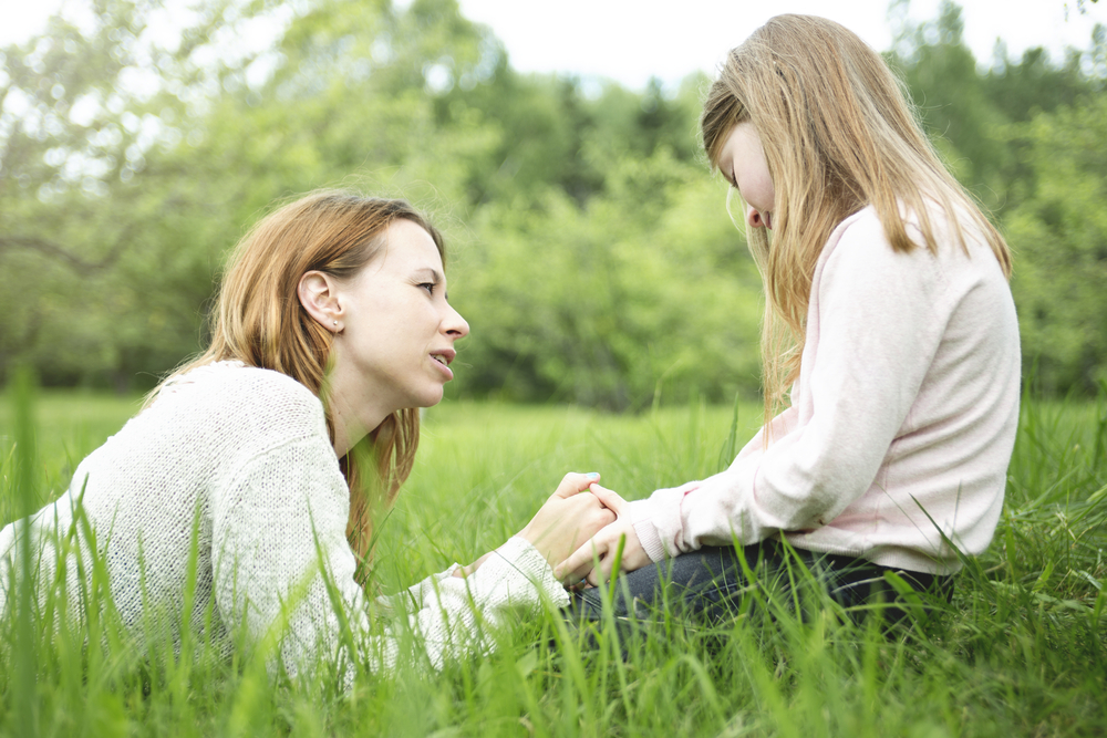 Mother And Daughter In A Field Talking About Life