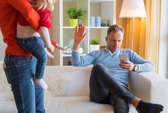 Young couple with father who is too busy to be a parent.