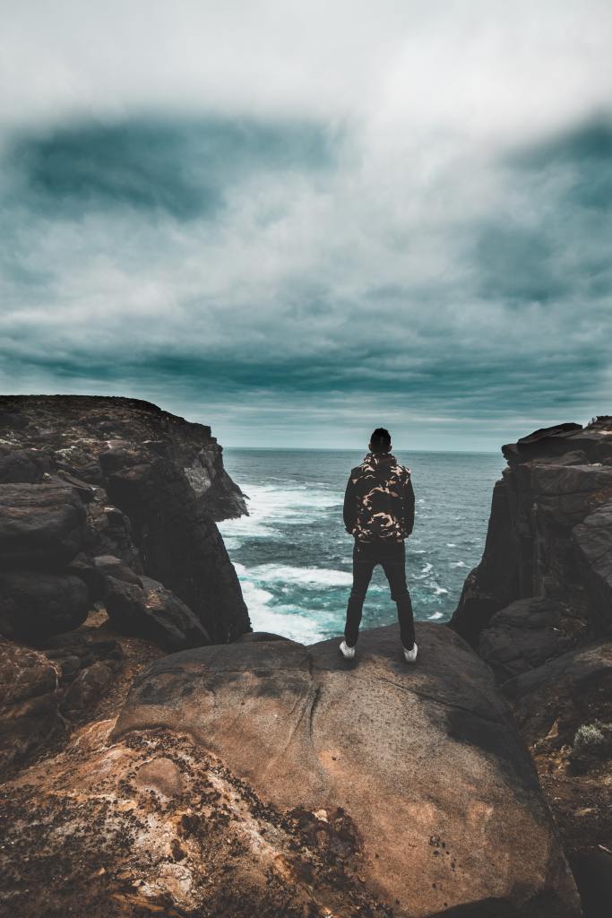 Man At The Crossroads. Decision Time. Jump. Cliff Edge. Dilemma.